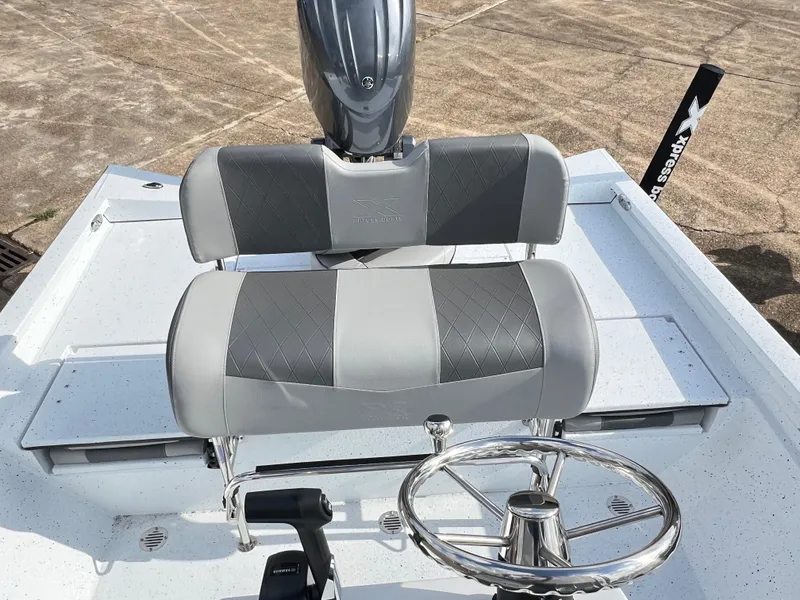 Slide: The Image of 2025 Xpress H22B HYPER-LIFT BAY boat interior with steering wheel and seating. - 8