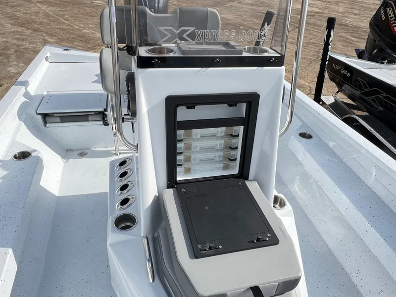 Slide: The Image of 2025 Xpress H22B Hyper-Lift Bay boat interior with storage compartments and rod holders. - 9