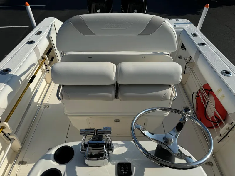 Slide: The Image of 2007 Boston Whaler 270 Outrage boat cockpit with steering wheel and seating. - 13