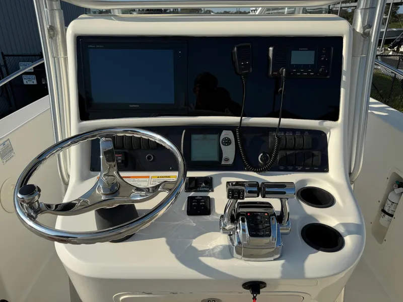 Slide: The Image of 2007 Boston Whaler 270 Outrage helm with steering wheel, controls, and navigation equipment. - 18