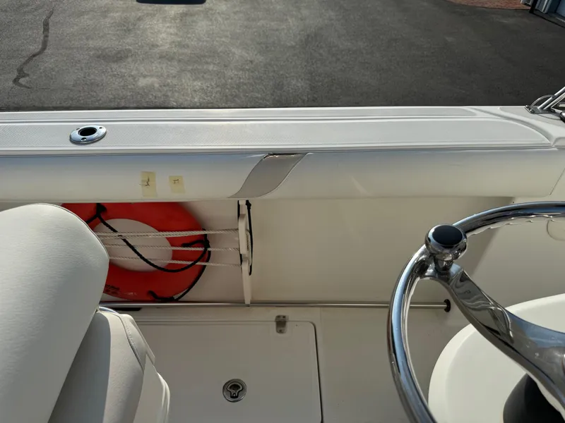 Slide: The Image of 2007 Boston Whaler 270 Outrage boat interior with life preserver and steering wheel. - 19