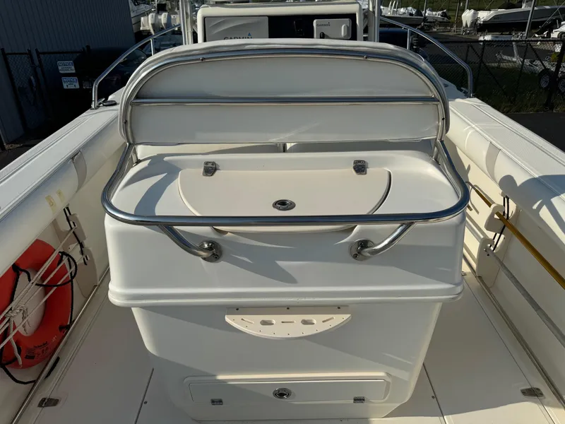 Slide: The Image of 2007 Boston Whaler 270 Outrage boat interior with storage compartment and safety equipment. - 23