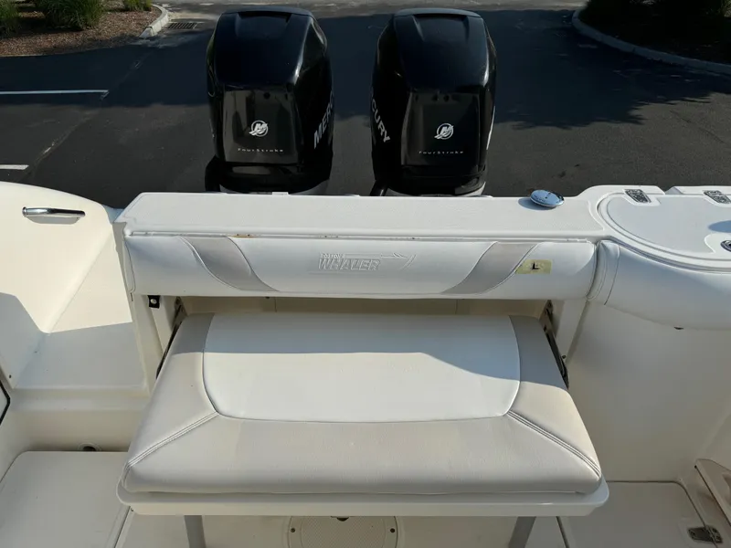 Slide: The Image of 2007 Boston Whaler 270 Outrage boat with twin Mercury engines and cushioned seating. - 24