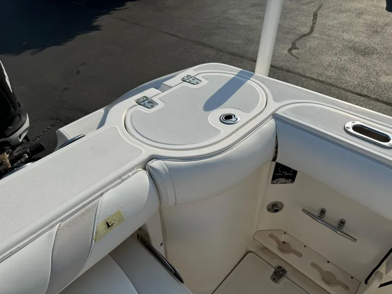 Slide: The Image of 2007 Boston Whaler 270 Outrage boat interior with white cushioned seating. - 26