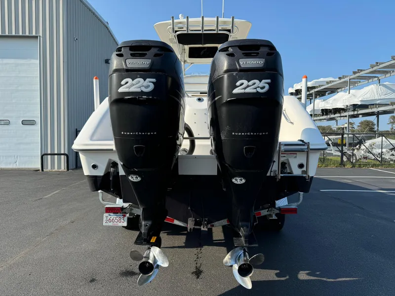 Slide: The Image of 2007 Boston Whaler 270 Outrage with twin 225 horsepower engines, docked at a marina. - 6