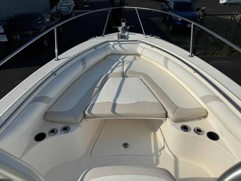Slide: The Image of 2007 Boston Whaler 270 Outrage boat bow seating area with white cushions. - 7