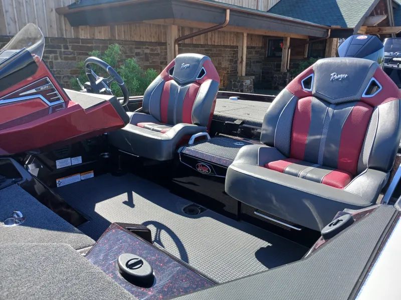 Slide: The Image of 2024 Ranger Z521R boat interior with red and gray seats, steering console. - 18