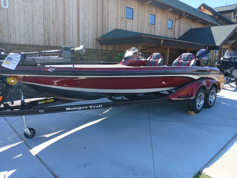 Slide: The Image of 2024 Ranger Z521R Ranger Cup Equipped boat, red and black, parked on a trailer. - 2