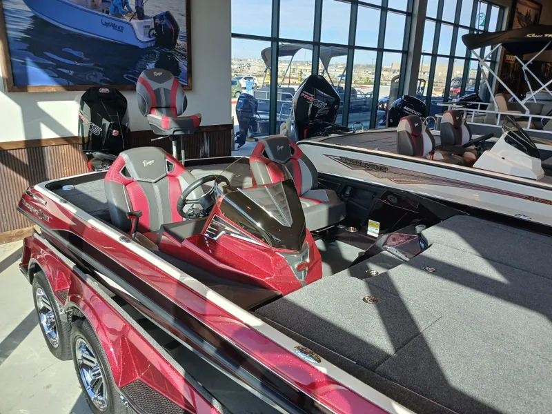 Slide: The Image of 2024 Ranger Z521R Ranger Cup Equipped boat in showroom, featuring sleek red design and modern seating. - 22
