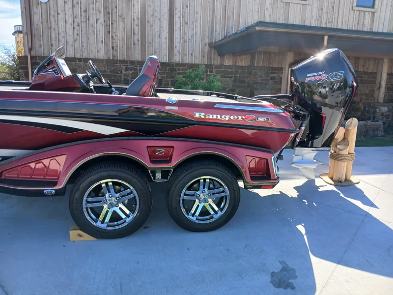 Slide: The Image of 2024 Ranger Z521R boat with dual wheels and powerful outboard motor. - 4