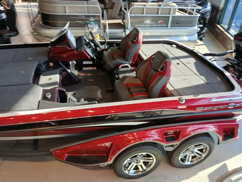 Slide: The Image of 2024 Ranger Z521R Ranger Cup Equipped boat with red and black design, dual seats, and chrome wheels. - 6