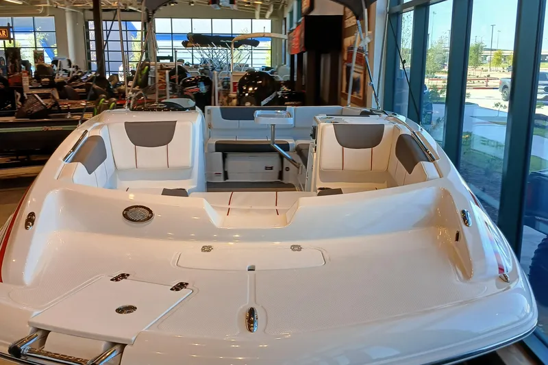 Slide: The Image of 2024 Tahoe 2150 boat interior in showroom, featuring spacious seating and modern design. - 4