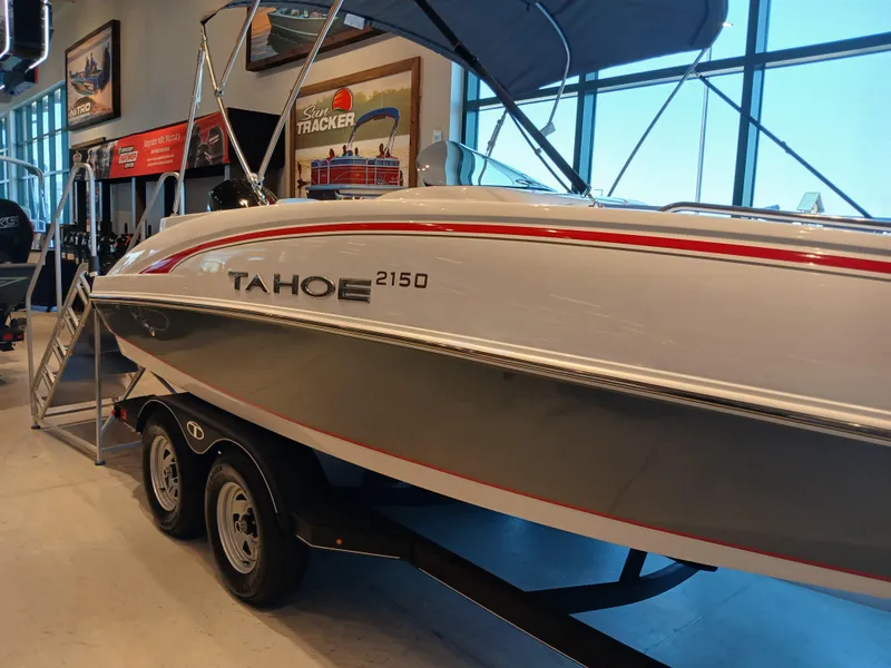 Slide: The Image of 2024 Tahoe 2150 boat on trailer in showroom, side view. - 6