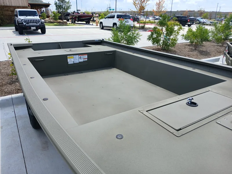 Slide: The Image of 2024 Tracker Grizzly 1754 Jon boat in parking lot, showcasing spacious interior design. - 4