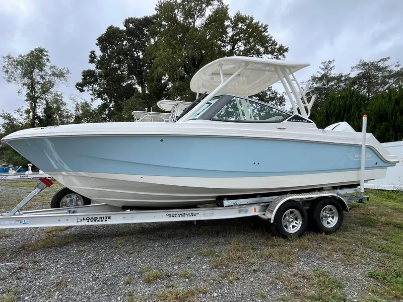 The Image of 2025 Boston Whaler 240 Vantage boat on trailer, light blue hull, parked outdoors. - 0