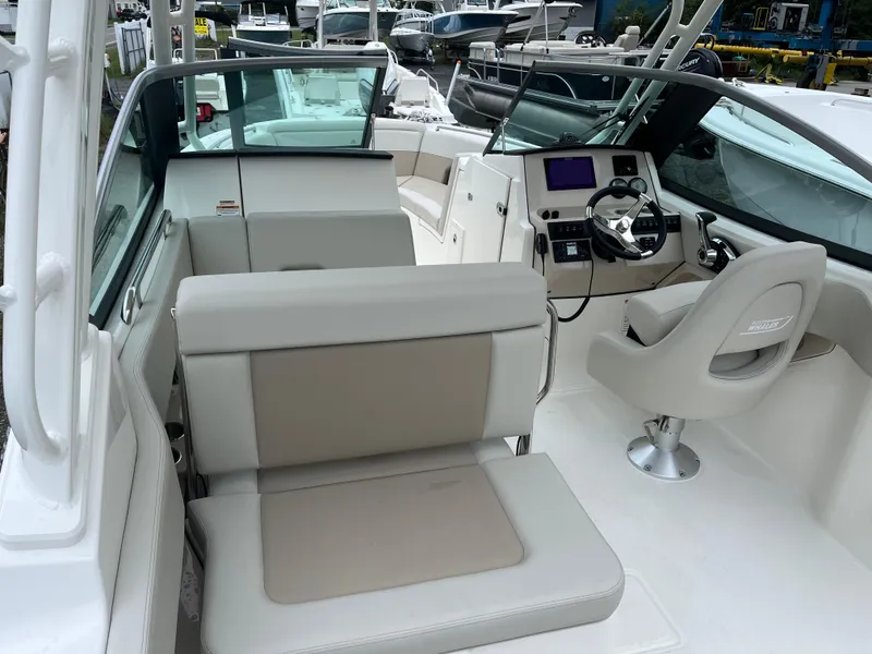 Slide: The Image of 2025 Boston Whaler 240 Vantage interior with modern seating and helm design. - 10