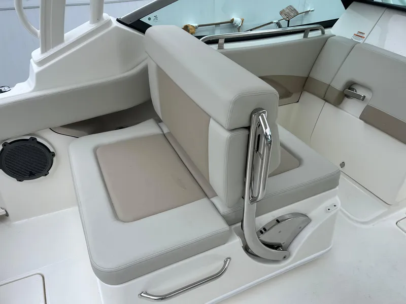 Slide: The Image of 2025 Boston Whaler 240 Vantage boat interior with cushioned seating and stainless steel accents. - 11