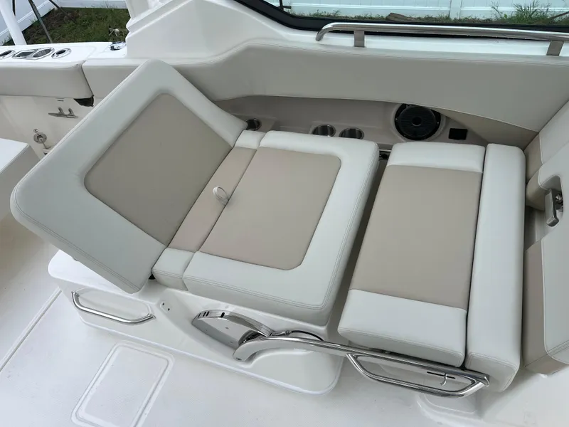 Slide: The Image of 2025 Boston Whaler 240 Vantage boat seating, featuring beige and white cushioned design. - 14