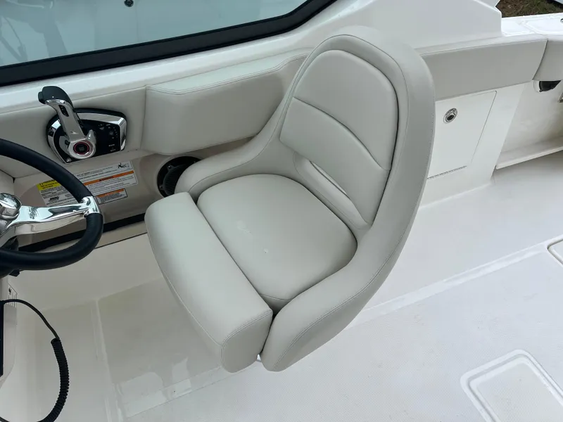 Slide: The Image of Captain's seat on 2025 Boston Whaler 240 Vantage boat, featuring sleek design and controls. - 16