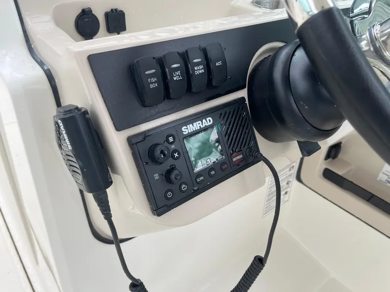 Slide: The Image of Control panel of 2025 Boston Whaler 240 Vantage with Simrad marine radio. - 19