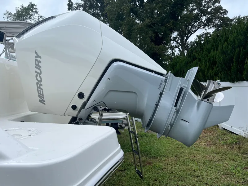 Slide: The Image of 2025 Boston Whaler 240 Vantage with Mercury outboard engine, displayed on grass. - 2