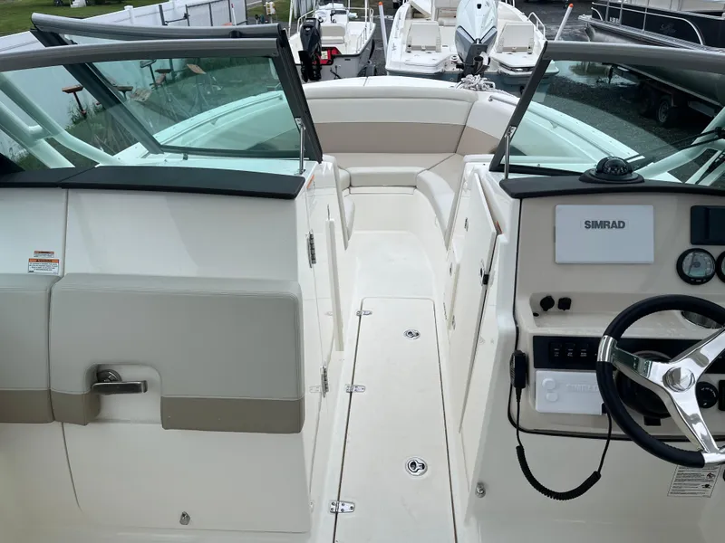 Slide: The Image of 2025 Boston Whaler 240 Vantage boat interior with steering wheel and seating area. - 22