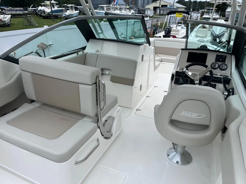 Slide: The Image of 2025 Boston Whaler 240 Vantage boat interior with seating and helm, showcasing modern design. - 5