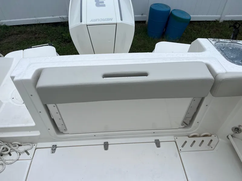 Slide: The Image of 2025 Boston Whaler 240 Vantage boat interior with Mercury engine, featuring a cushioned seat. - 7