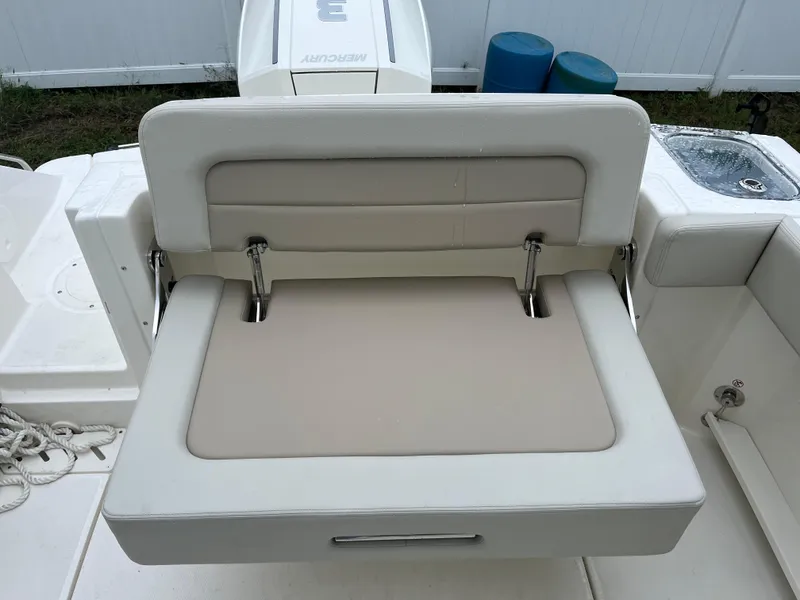 Slide: The Image of 2025 Boston Whaler 240 Vantage boat seat, beige and white upholstery, rear view. - 8