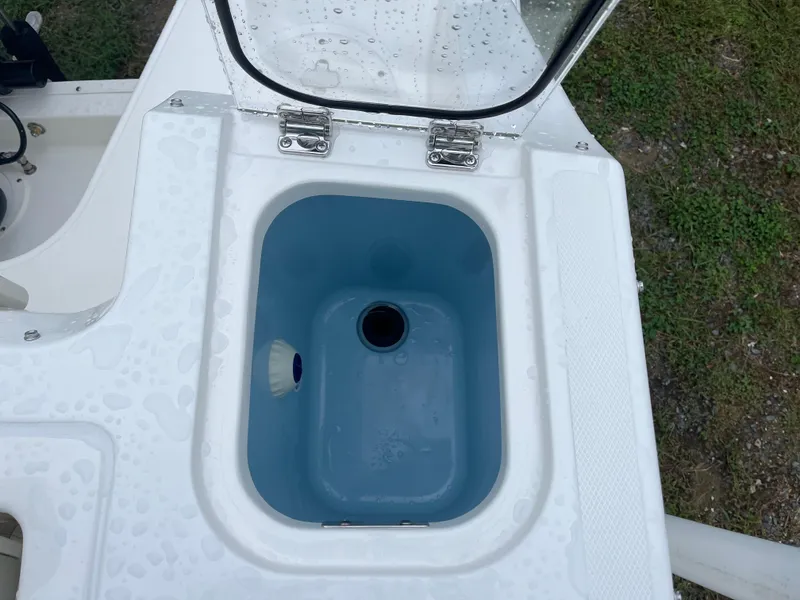 Slide: The Image of Livewell compartment on a 2025 Boston Whaler 240 Vantage boat, featuring a blue interior. - 9