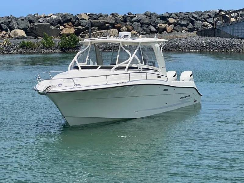The Image of 2008 Hydra-Sports 3500VX boat on calm water near rocky shore. - 0