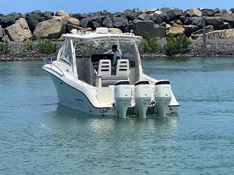 Slide: The Image of 2008 Hydra-Sports 3500VX boat with triple outboard engines on calm water. - 15