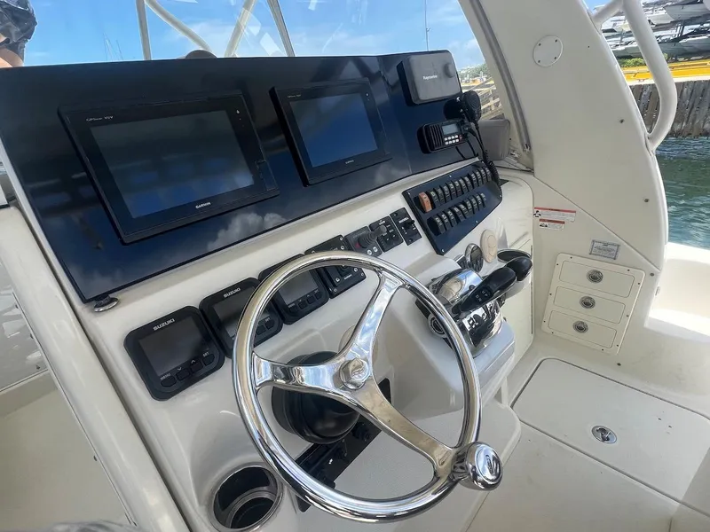 Slide: The Image of 2008 Hydra-Sports 3500VX boat helm with modern navigation equipment and controls. - 21
