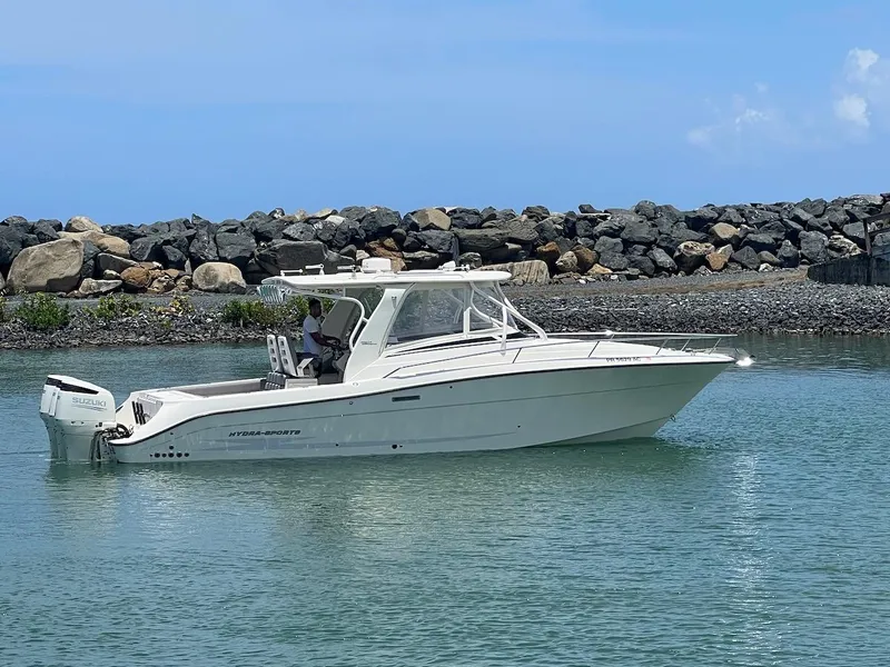 Slide: The Image of 2008 Hydra-Sports 3500VX boat on calm water near rocky shore. - 9