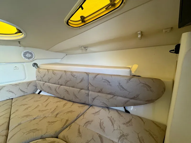 Slide: The Image of Interior cabin of a 2006 Hydra-Sports 3300 VX boat with cushioned seating. - 10
