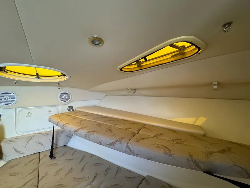 Slide: The Image of 2006 Hydra-Sports 3300 VX cabin interior with cushioned seating and portholes. - 11