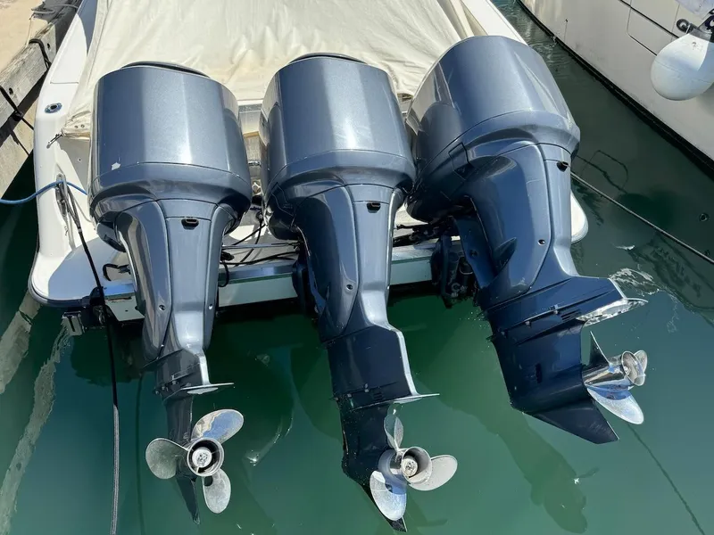 Slide: The Image of 2006 Hydra-Sports 3300 VX boat with triple outboard motors docked in marina. - 15