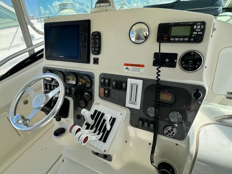 Slide: The Image of 2006 Hydra-Sports 3300 VX boat helm with steering wheel, controls, and navigation equipment. - 4