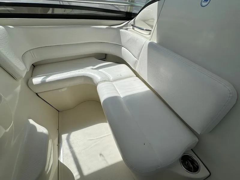 Slide: The Image of 2006 Hydra-Sports 3300 VX boat interior seating area with white upholstery. - 6