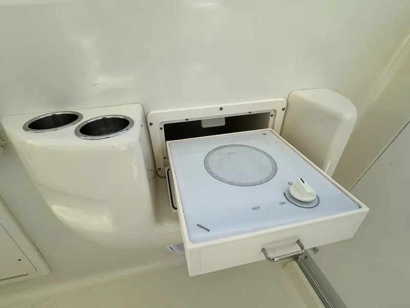 Slide: The Image of 2006 Hydra-Sports 3300 VX boat interior with built-in stove and cup holders. - 7