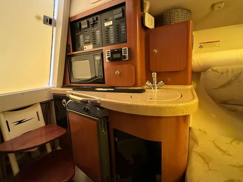 Slide: The Image of 2006 Hydra-Sports 3300 VX cabin interior with kitchenette and control panel. - 8