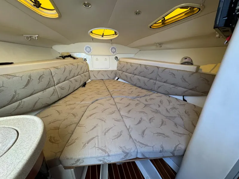 Slide: The Image of 2006 Hydra-Sports 3300 VX cabin interior with cushioned seating and overhead lighting. - 9