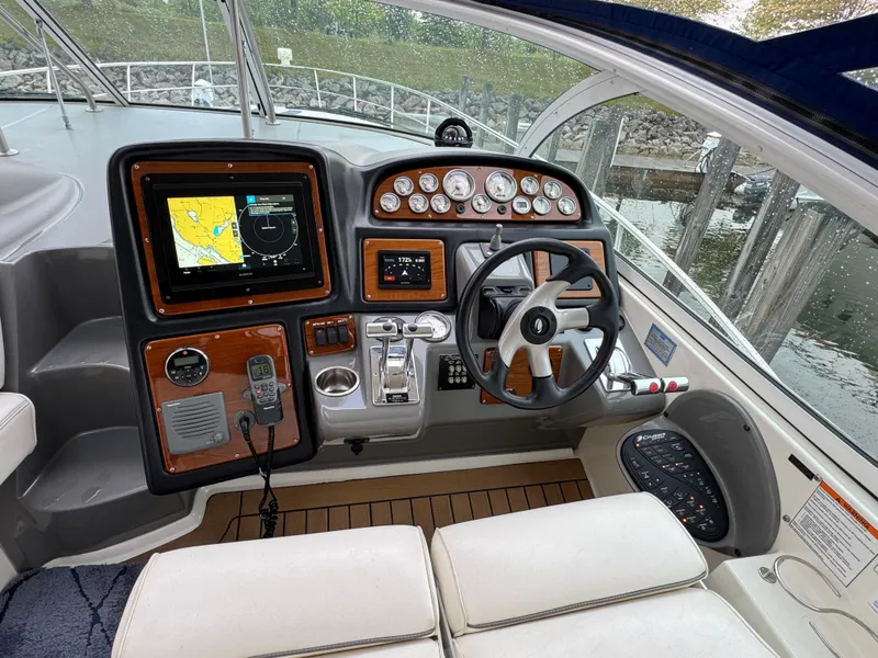 Slide: The Image of Helm of 2006 Cruisers Yachts 420 Express with navigation equipment and steering wheel. - 17