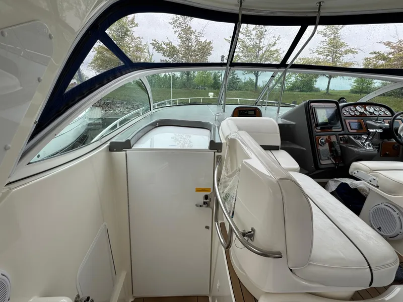 Slide: The Image of 2006 Cruisers Yachts 420 Express cockpit with white seating and control panel. - 19