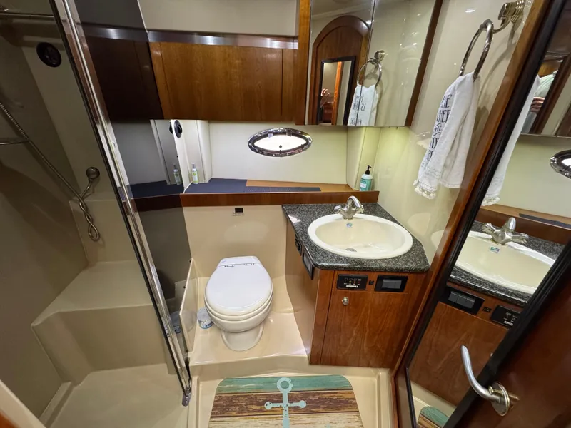 Slide: The Image of Luxurious 2006 Cruisers Yachts 420 Express bathroom with modern amenities and elegant wood finishes. - 31