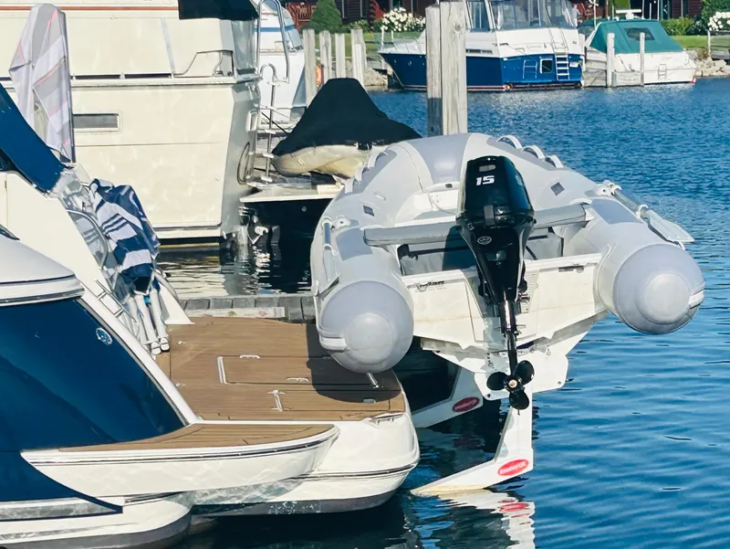 Slide: The Image of 2006 Cruisers Yachts 420 Express docked with inflatable boat and outboard motor. - 38