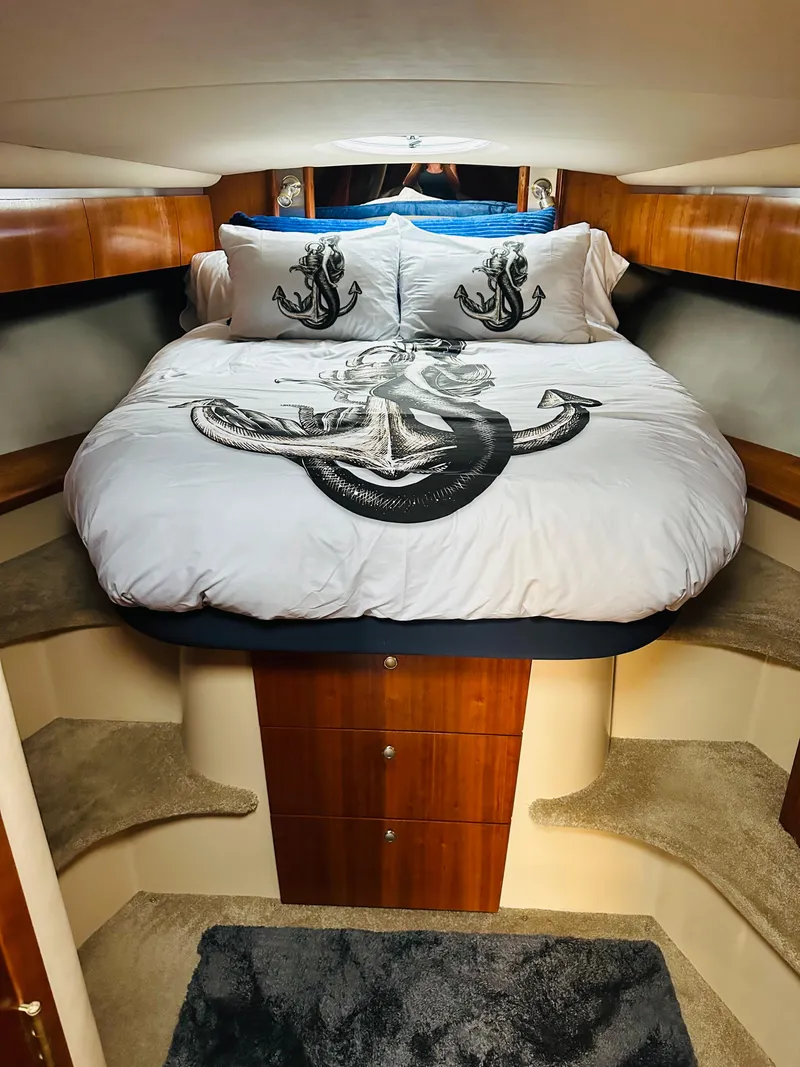 Slide: The Image of Luxurious 2006 Cruisers Yachts 420 Express cabin with anchor-themed bedding. - 39