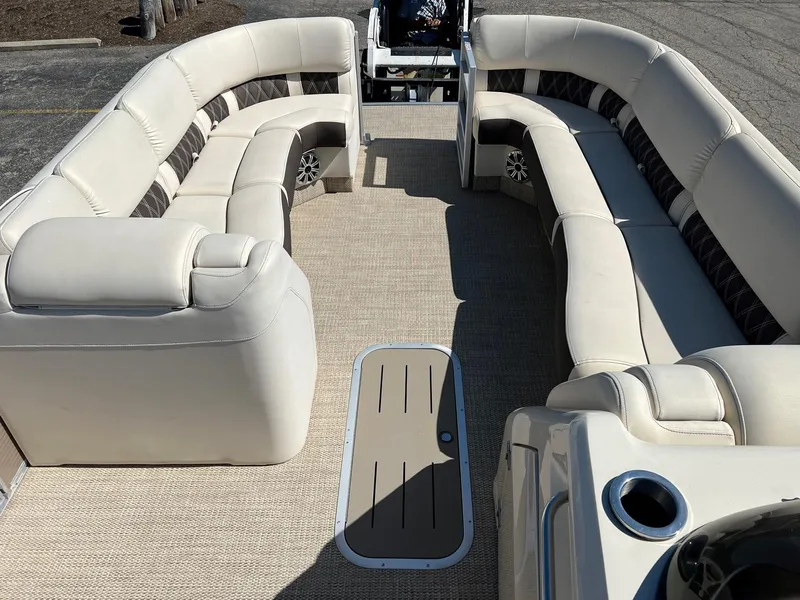 Slide: The Image of 2020 Bennington R 25 RSB pontoon boat interior with beige seating and carpet. - 2
