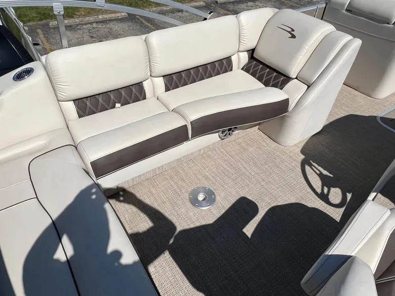 Slide: The Image of 2020 Bennington R 25 RSB boat interior with beige and brown seating. - 5