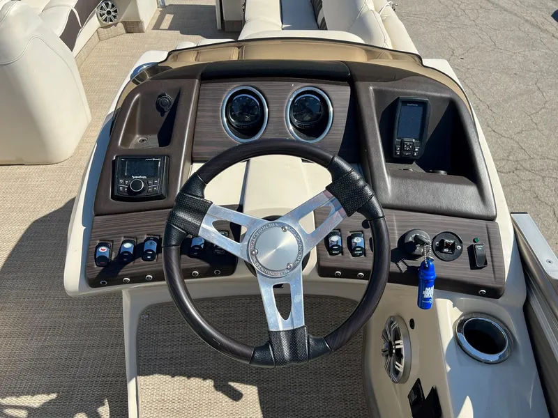 Slide: The Image of 2020 Bennington R 25 RSB boat dashboard with steering wheel and control panel. - 8